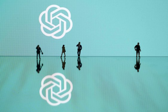 This photograph taken in Mulhouse, eastern France on October 19, 2023, shows figurines next to the ChatGPT logo. (Photo by SEBASTIEN BOZON/AFP via Getty Images)