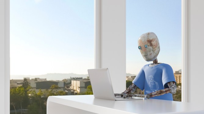 Robot working in office, using laptop